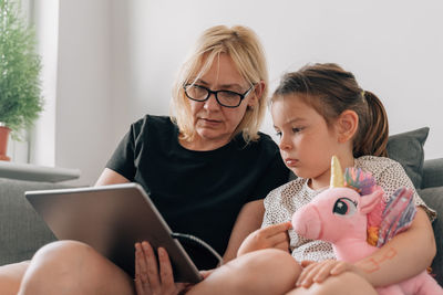 Young woman using laptop while sitting at home