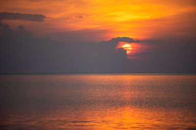 Scenic view of sea against romantic sky at sunset