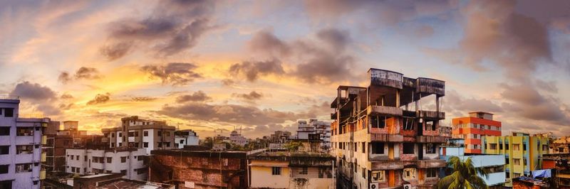 Buildings against cloudy sky