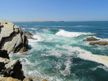 Scenic view of sea against clear blue sky