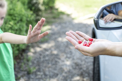 Daughter refusing food from father sitting in car 