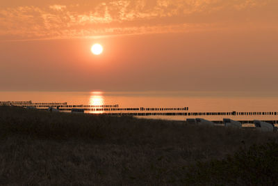 Scenic view of beach against sky during sunset