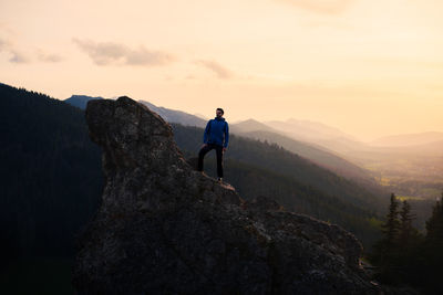 Rear view of man standing on mountain