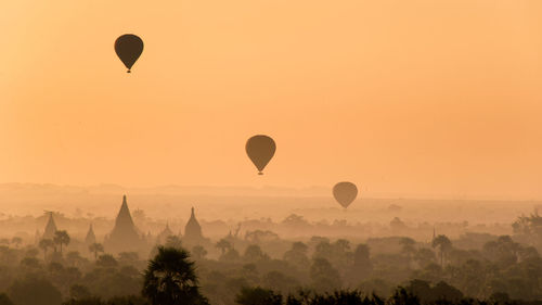 Hot air balloons against sky during sunset
