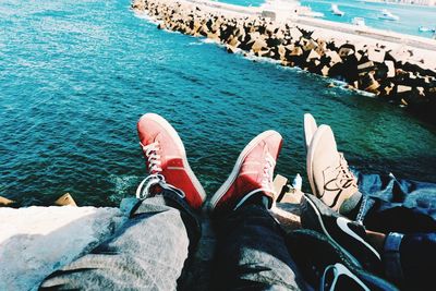 Low section of person on rocks by sea