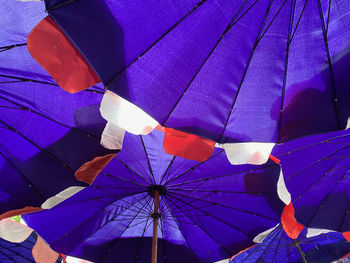 Low angle view of blue beach umbrellas