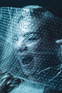 Close-up portrait of woman with bubble wrap