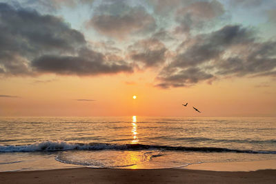 Scenic view of sea against sky during sunset