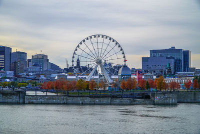 Ferris wheel in city against sky