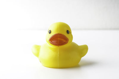 Close-up of yellow toy over white background