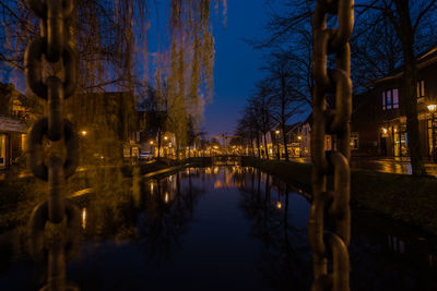 Reflection of illuminated buildings in canal at night