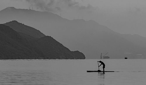 Scenic view of sea against mountain range