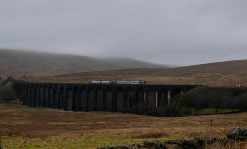 Train on the tracks at ribblehead viaduct 