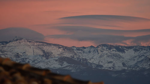 Scenic view of snowcapped mountains against sky during sunset