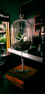 Close-up of glass bottles hanging on table in restaurant