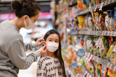 Friends holding ice cream in store