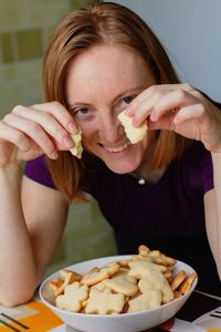 Portrait of young woman holding ice cream in plate