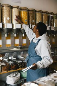 Young owner checking inventory in food store