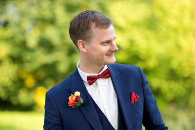 Close-up of bridegroom in park