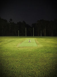 Scenic view of soccer field against sky at night