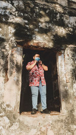 Full length of man standing at abandoned building