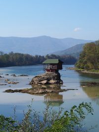 Scenic view of lake and mountains against sky