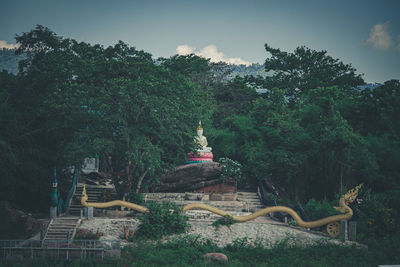 Statue of temple against cloudy sky