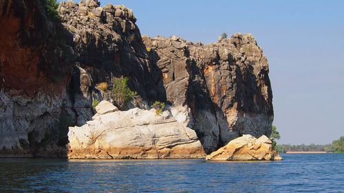 Scenic view of rock formation and sea against sky