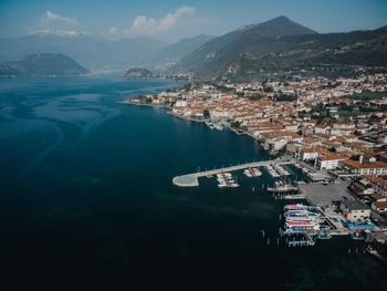 High angle view of city by sea against sky