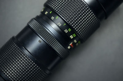 Close-up of camera lens on table