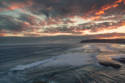 Scenic view of beach against sky during sunset