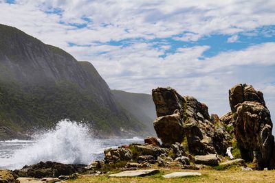 Scenic view of rocks and sea against sky