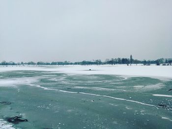 Scenic view of frozen lake against clear sky