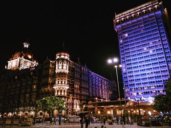 Low angle view of illuminated buildings at night