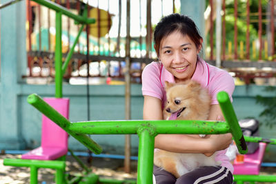 Portrait of cute girl sitting outdoors