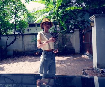 Portrait of man standing against building