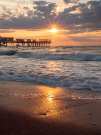 Scenic view of beach against sky during sunset