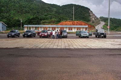 Vehicles on road against mountain