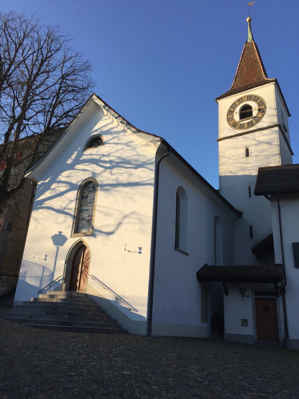 building exterior, architecture, built structure, low angle view, religion, clear sky, place of worship, church, house, building, roof, day, residential structure, outdoors, spirituality, old, tree, residential building