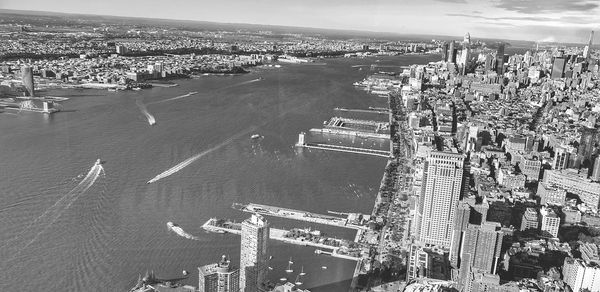 High angle view of buildings by sea against sky