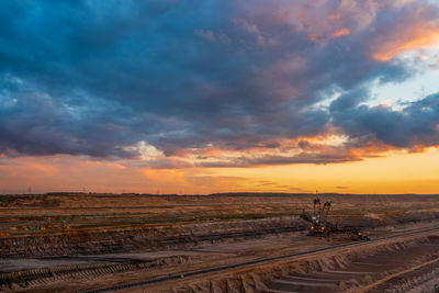 Scenic view of beach against sky during sunset