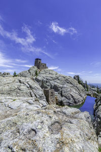 Rock formation on land against blue sky