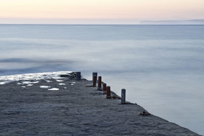 Scenic view of sea against clear sky at sunset