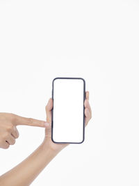 Hand holding smart phone over white background