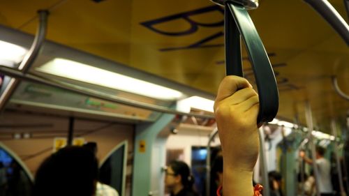 Close-up of hand in train