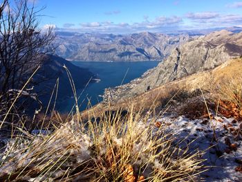 Scenic view of snowcapped mountains by sea against sky