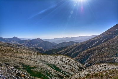 Scenic view of mountains against clear sky on sunny day