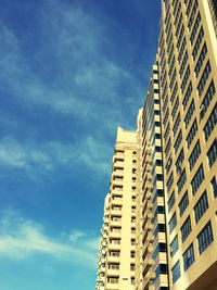 Low angle view of modern building against blue sky