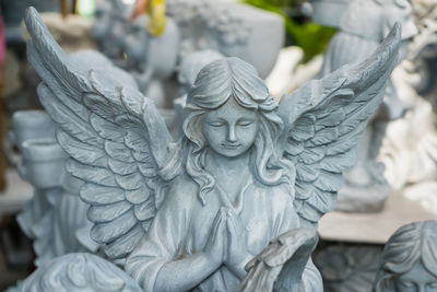 Beautiful stucco dolls decorate a beautiful garden in a garden supply store in bangkok thailand.