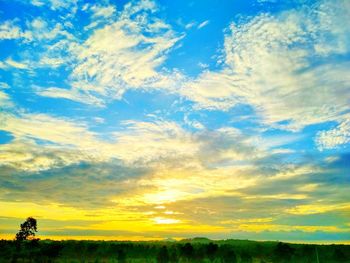 Scenic view of field against sky at sunset